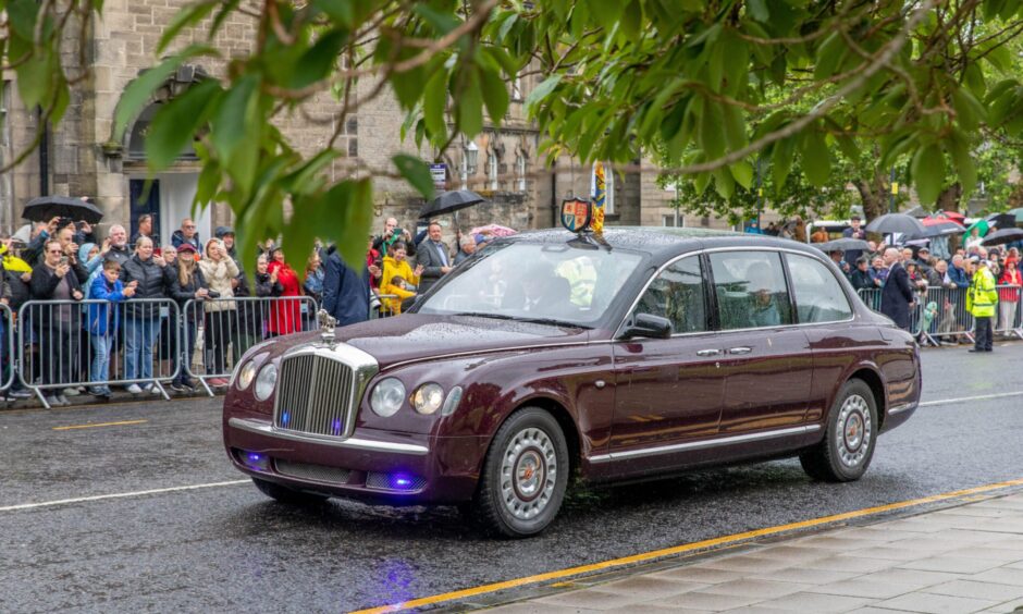 The Royal Couple arrive in a car bearing the royal crest