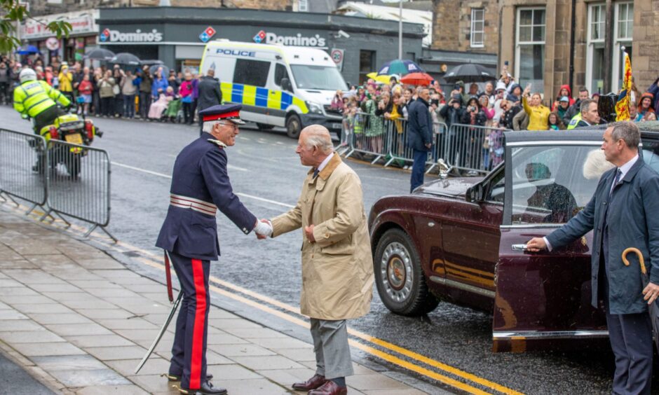 King Charles shakes hands with Lord Lieutenant of Fife, Robert Balfour.