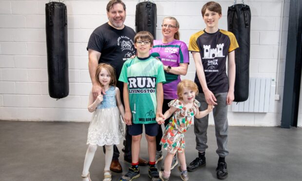 Perth couple Ben Finch and Nic Crossley with their children at Perth Fitness Studios.