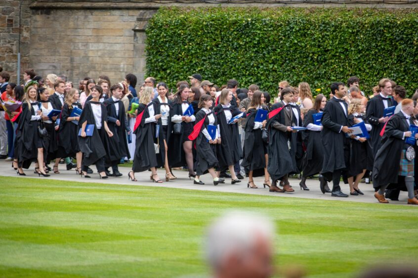 Graduates make their way to St Salvator's Quad after the ceremony at St Andrews University graduation.