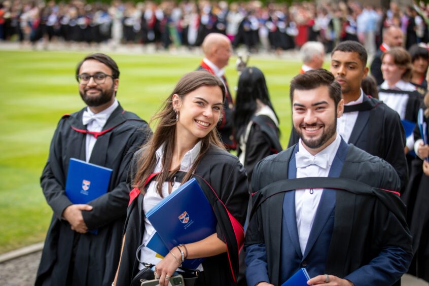 Graduates make their way to St Salvator's Quad after the ceremony at St Andrews University graduation.