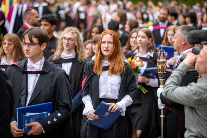 Graduates make their way to St Salvator's Quad after the ceremony at St Andrews University graduation.