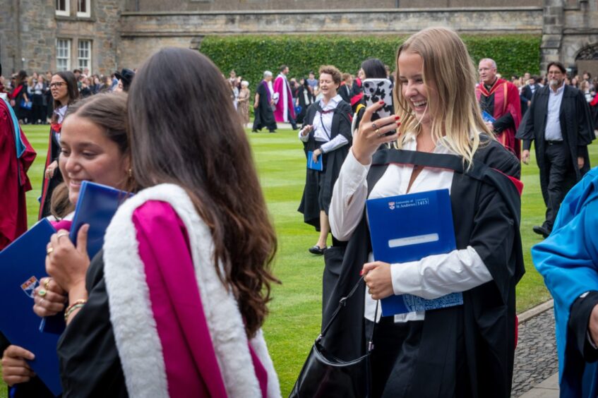 Graduates make their way to St Salvator's Quad after the ceremony at St Andrews University graduation.