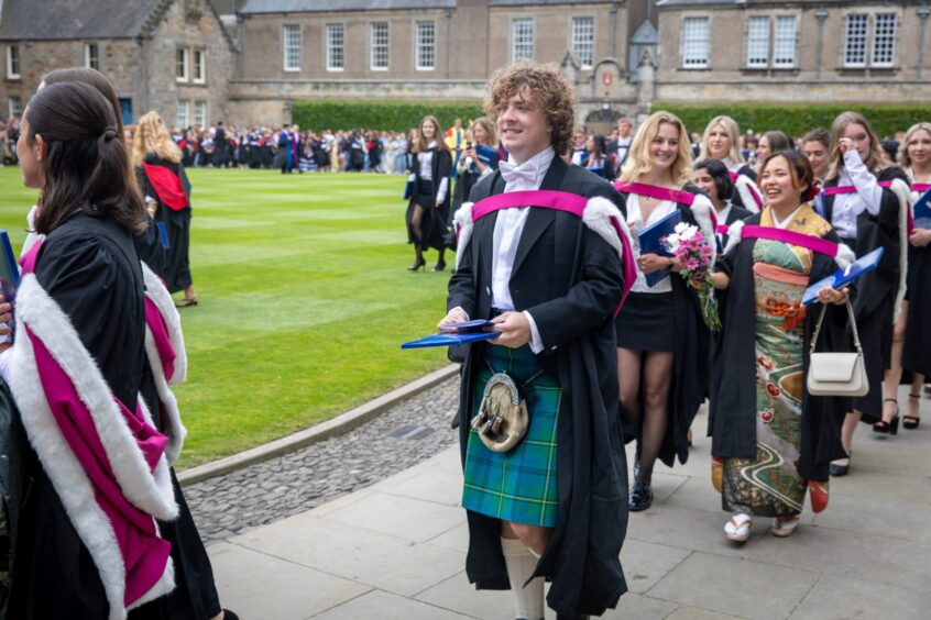 Graduates make their way to St Salvator's Quad after the ceremony at St Andrews University graduation.