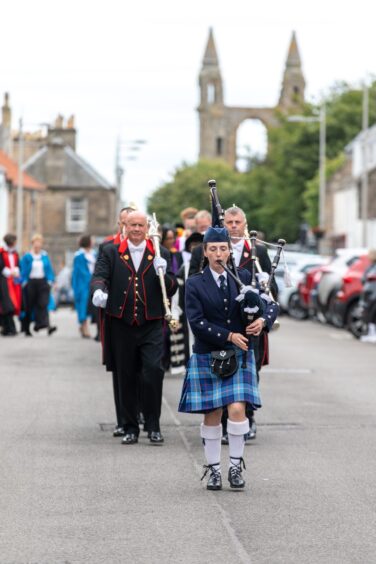 A bagpiper plays.