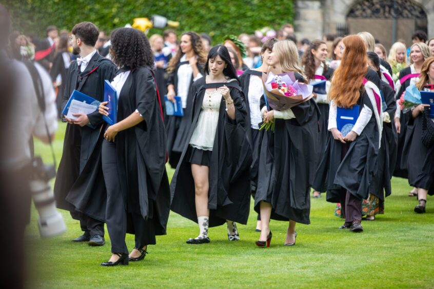 Graduates make their way to St Salvator's Quad after the ceremony at St Andrews University graduation.