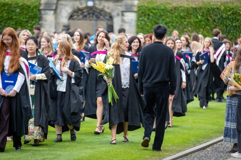 Graduates make their way to St Salvator's Quad after the ceremony at St Andrews University graduation.