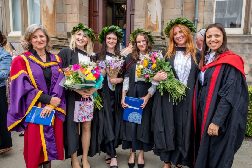 Graduates pose for a group photo after the ceremony.