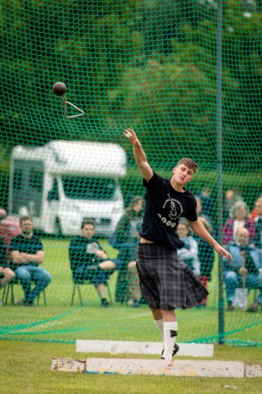 A man releases the weight throw at St Andrews Highland Games.