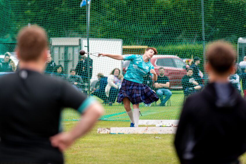 A male competitor winds up for the weight throw at St Andrews Highland Games.