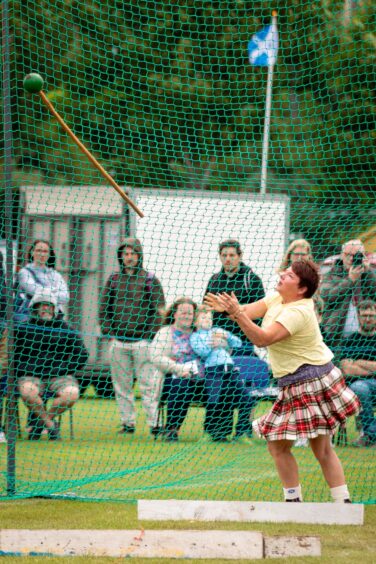 A woman releases the hammer throw at St Andrews Highland Games.