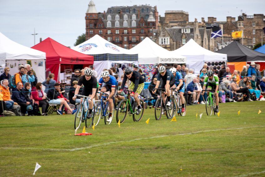 A group of cyclists on the field at St Andrews Highland Games.