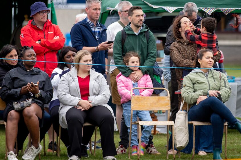 A crowd people looking on at St Andrews Highland Games.