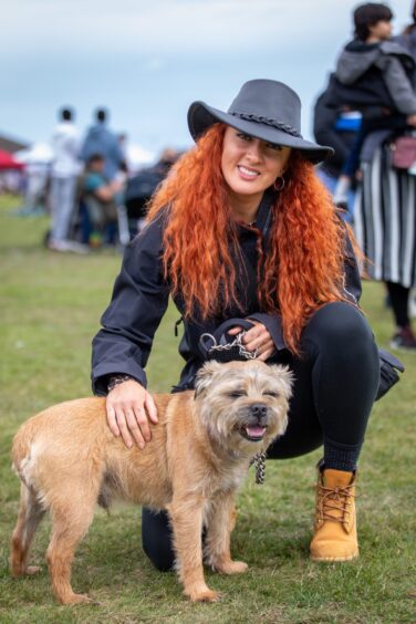 A lady and her dog enjoy the St Andrews Highland Games.