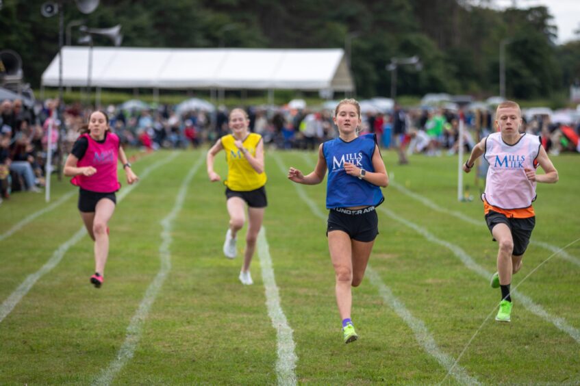 Runners take to the track during the St Andrews Highland Games.