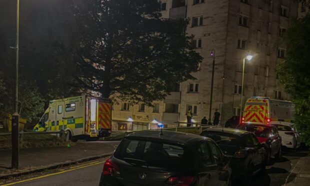 Emergency services at Hilltown Court in Dundee after a man fell from the building. Image: Adam Ward