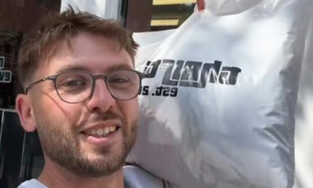 Influencer Spencer Gully outside the Dundee vintage store.