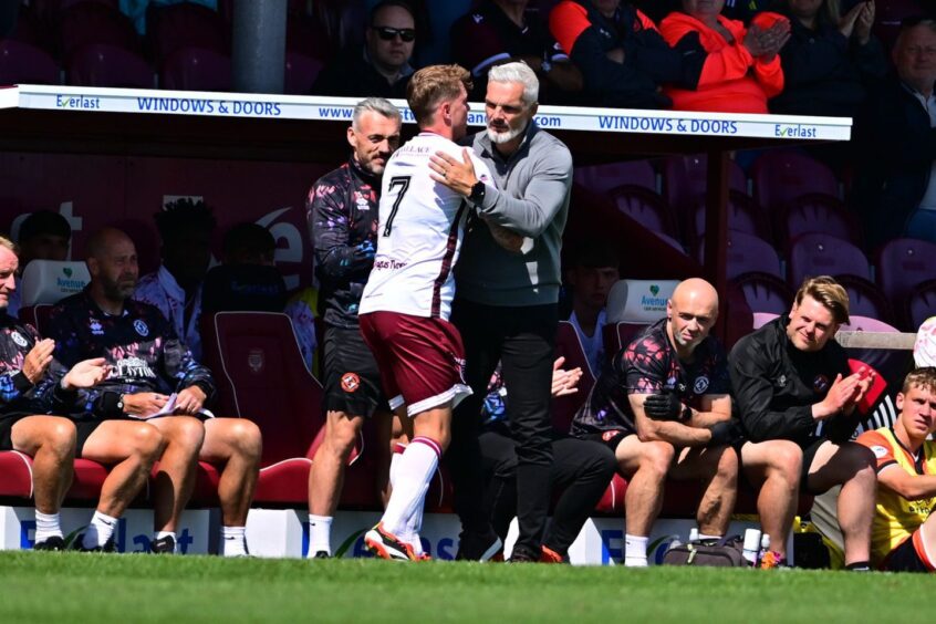 Jim Goodwin embraces David Gold on the touchline