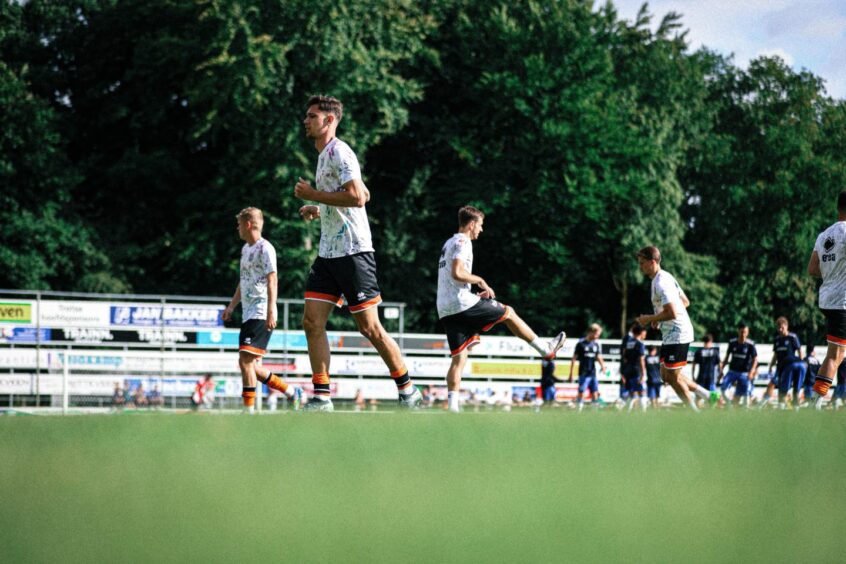The United players warm-up in the Oldenbroek sun