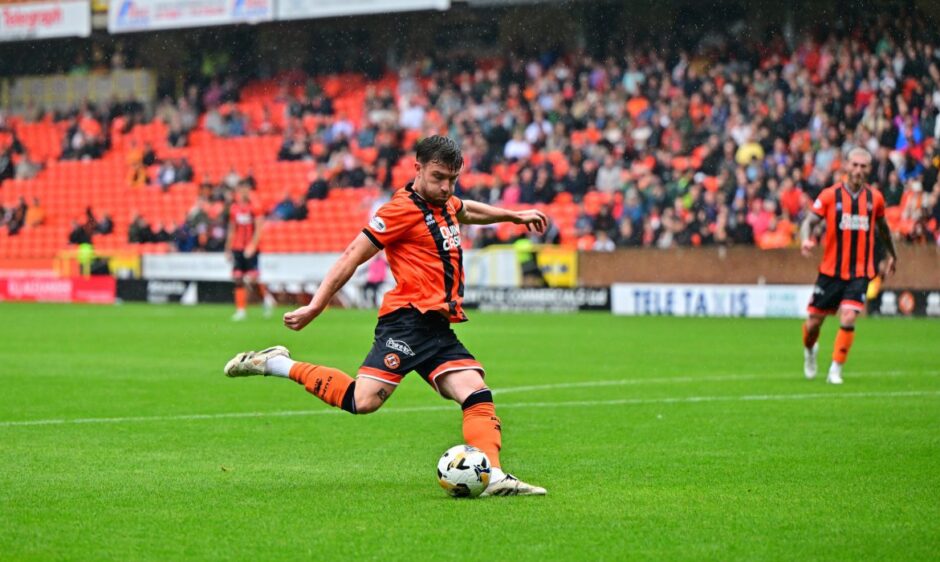 Ryan Strain winds up to strike, only for his effort to be superbly blocked by Bevis Mugabi
