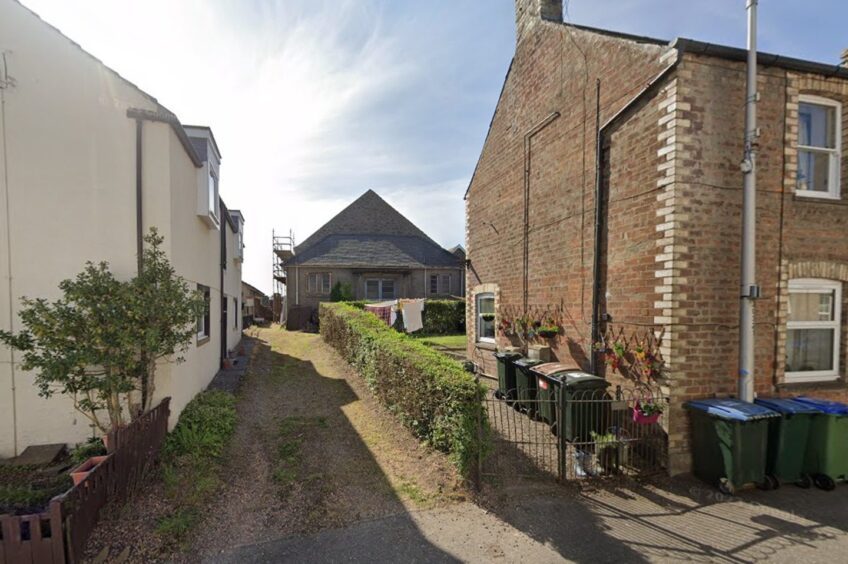 Entrance between two properties to Bruce Hall showing building on slight hill with 21st century extension on this end