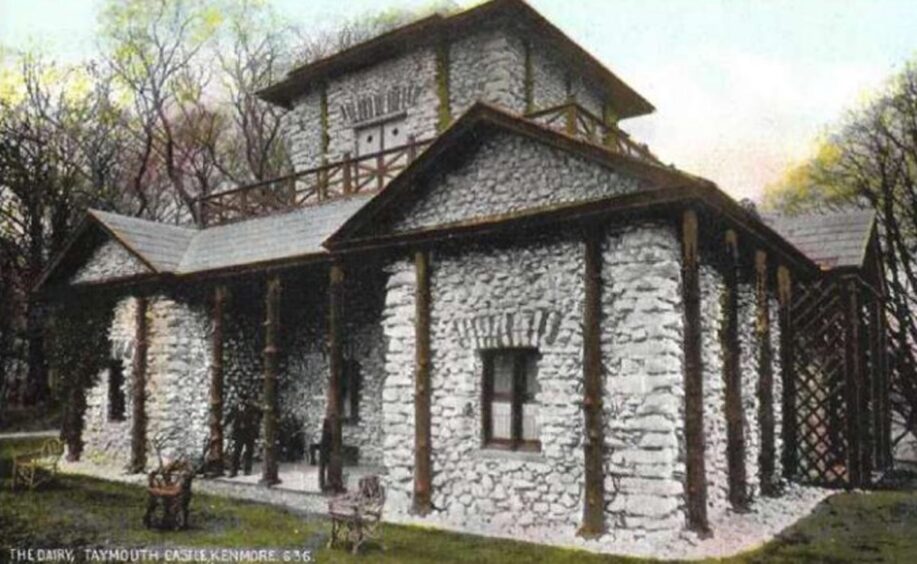 Postcard showing white stone building with dark timber outside and square central tower