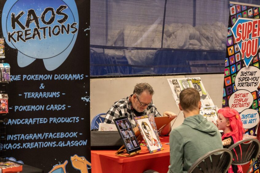 Attendees pay a visit to a portrait artist.