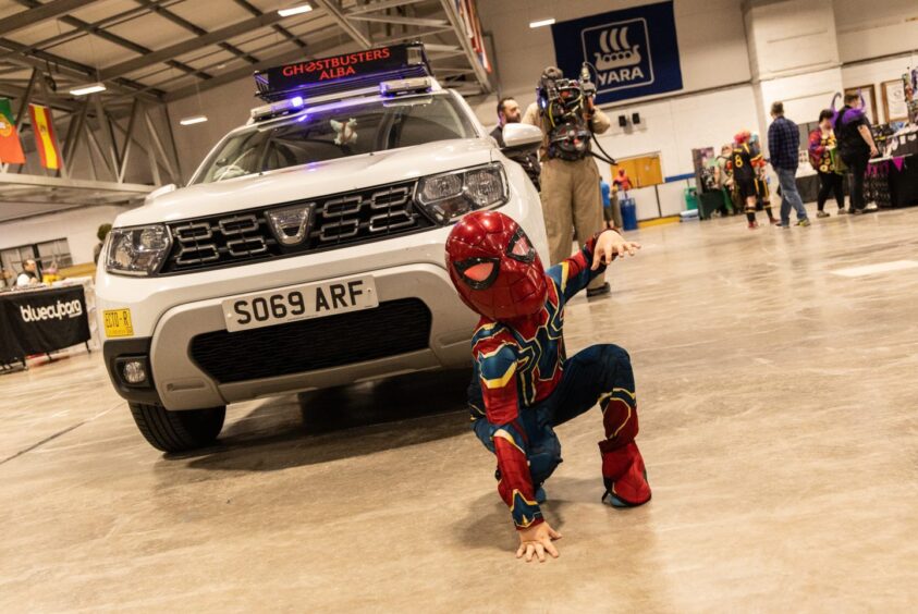 A young man dressed in a Spider-Man costume.