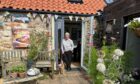 Image shows a pretty cottage in Pittenweem decorated for the Arts Festival with artist Georgie Young.