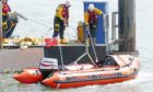 Montrose RNLI crew preparing to go to the rescue of the beached dolphin. Image: Montrose RNLI
