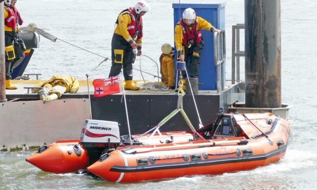 Montrose RNLI crew preparing to go to the rescue of the beached dolphin. Image: Montrose RNLI