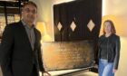 Hotel Indigo manager Manny Baber helped return a vintage chest to guest Briony Nimmo.