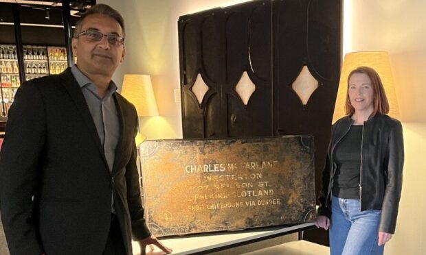 Hotel Indigo manager Manny Baber helped return a vintage chest to guest Briony Nimmo.