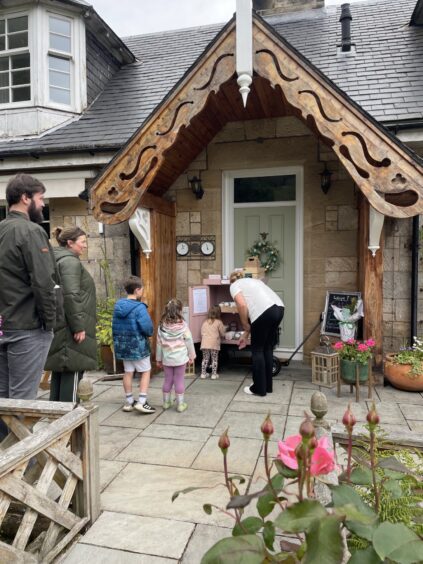 Claire Sara interacting with her customers at the cake shed.
