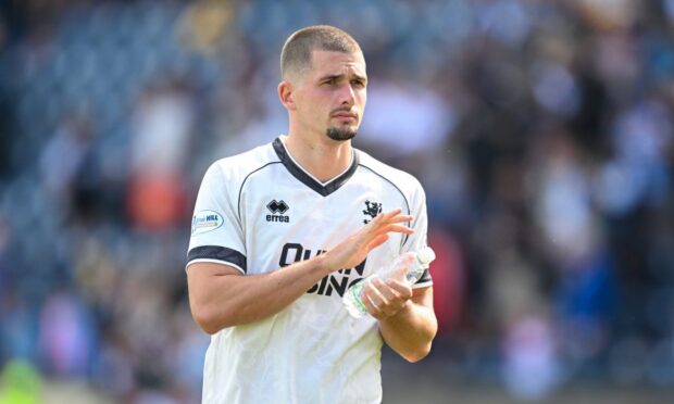 Max Watters applauds the travelling Dundee United fans
