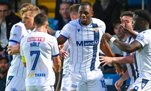 The St Johnstone players celebrate with Uche Ikpeazu.