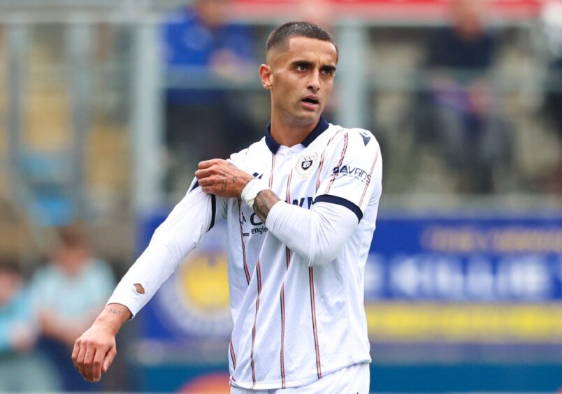 Yan Dhanda walks while playing for Dundee FC