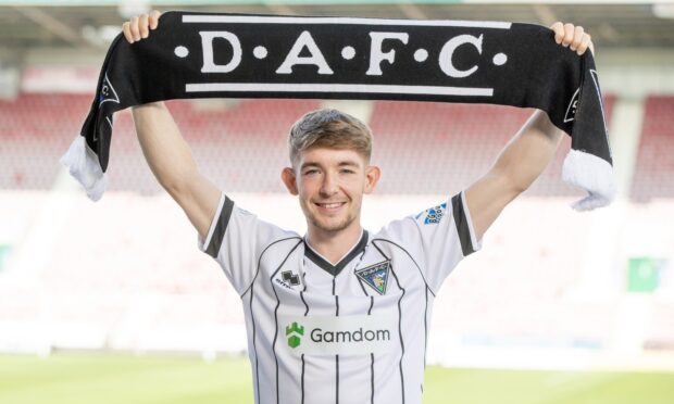 Robbie Fraser holds up a DAFC scarf.