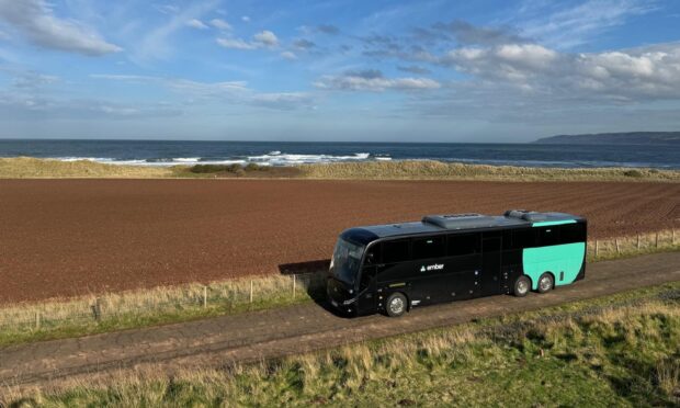 An Ember bus in countryside.