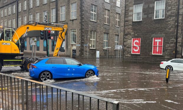 A car struggling in the rain at West Marketgait, Dundee
