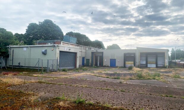 Derelict former ABP abattoir in Perth showing boarded up buildings and weeds