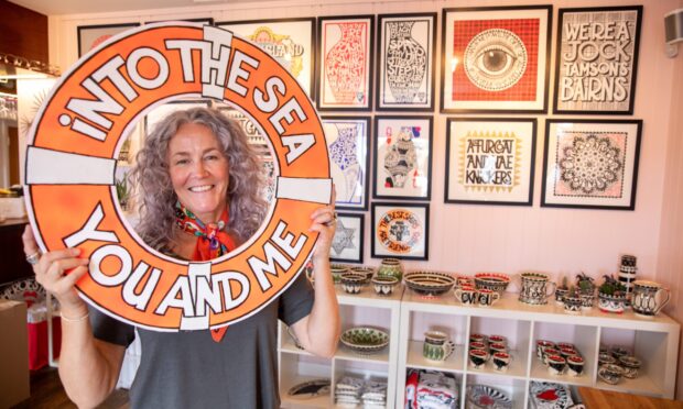 Artist Susan McGill sets up her work for Pittenweem Arts Festival.