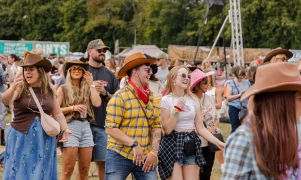 people in the crowd wearing cowboys hats at a previous Summer in Nashville event