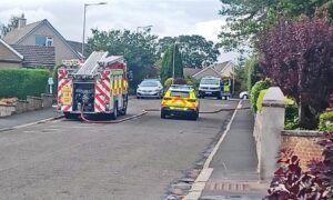 Emergency services are at the scene on Kinnordy Road. Image: Lindsey Hamilton
