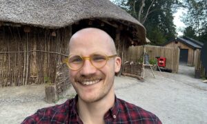 Jacob Smith posing in front of a roundhouse.