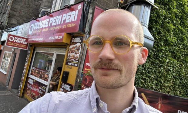 Jacob Smith standing outside a Hilltown takeaway.