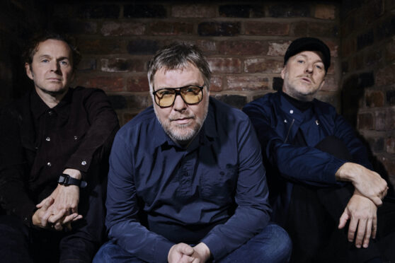 the three members of Doves sit down to pose for a press shot