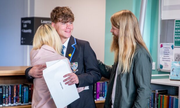 CR0054348, Cheryl Peebles, Dunfermline. Exam Results day in Dunfermline. Picture Shows: Caleb Fyffe from Woodmill High School in Dunfermline opening their exam results. Tuesday 5th August 2025. Image: Steve Brown/DC Thomson
