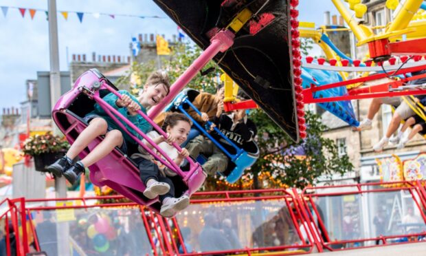 Oliver Elliott (10) and Mollie O'Kane (9) from Glasgow scream as they ride the Sky Diver. Image: Steve Brown/DC Thomson