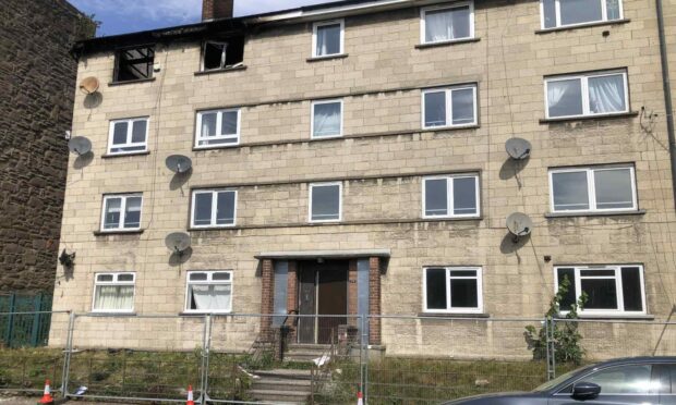 The fats on Watson Street, Dundee, have been fenced off after the fire. Image: James Simpson/DC Thomson